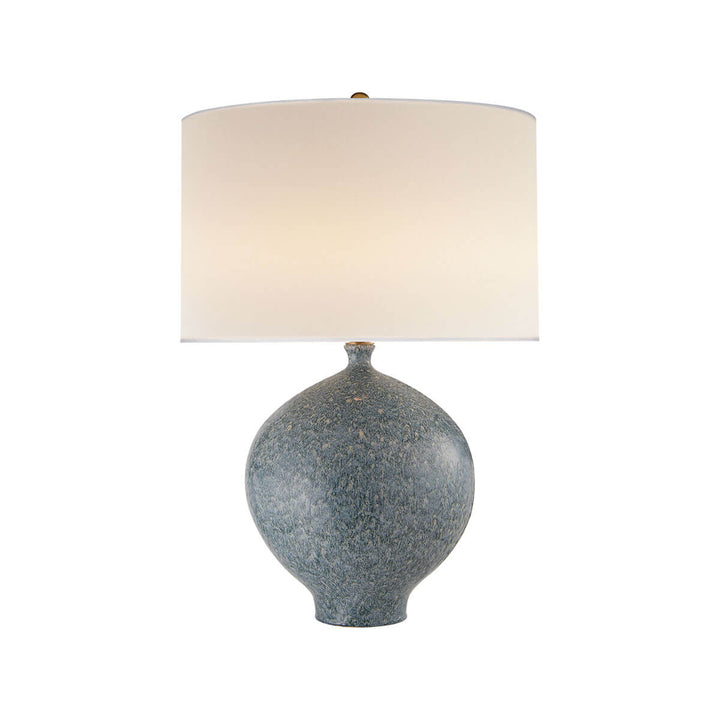 The Gaios Table Lamp has a rounded, textured blue lagoon body and a round linen shade.