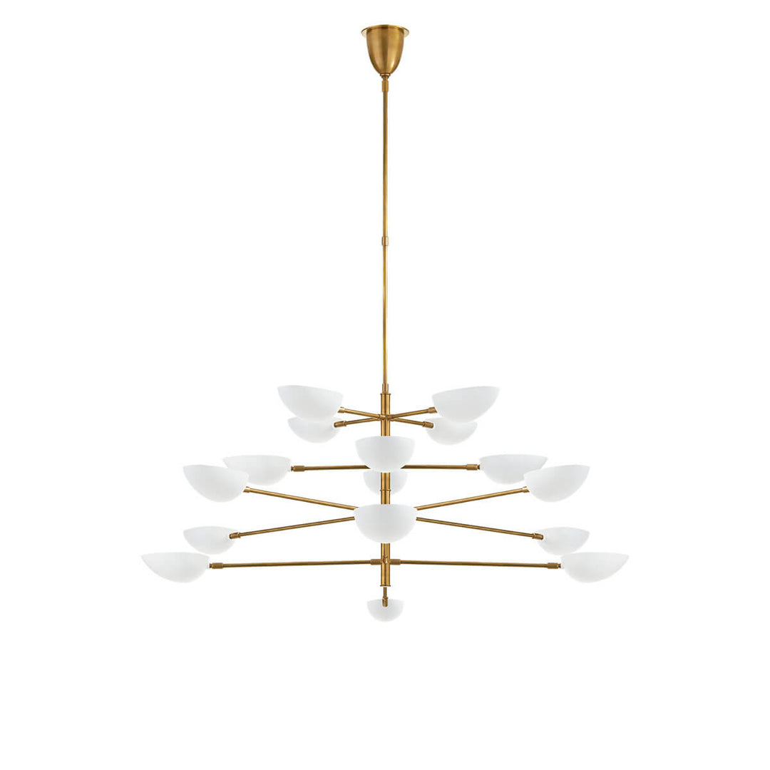 The Graphic Grande Multi-Tier Chandelier has a rod stem and tiered arms in a hand-rubbed antique brass finish and has sixteen lights with white glass, pedal shaped shades.