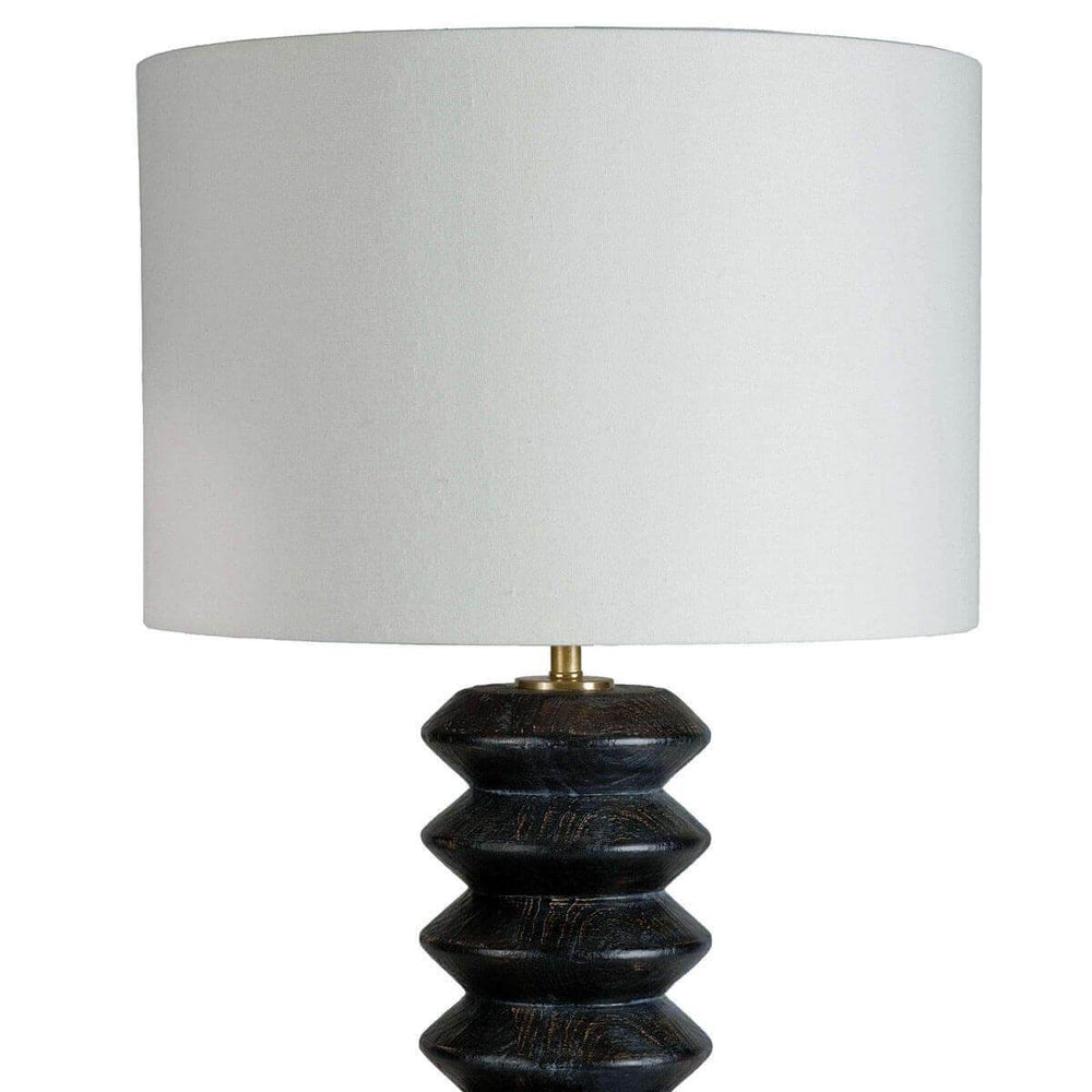 Dark ebony carved wood base with contrasting white linen lamp shade.