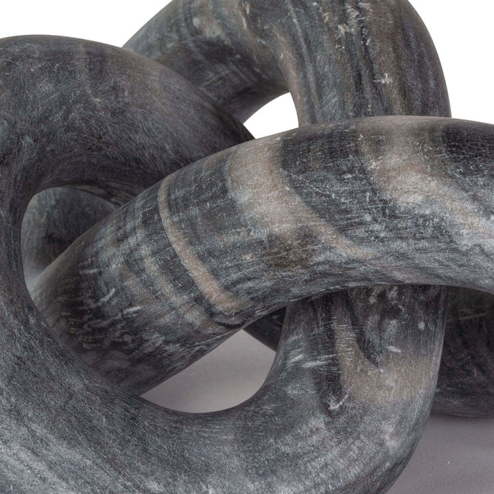 Close up of black marble knotted sculpture.