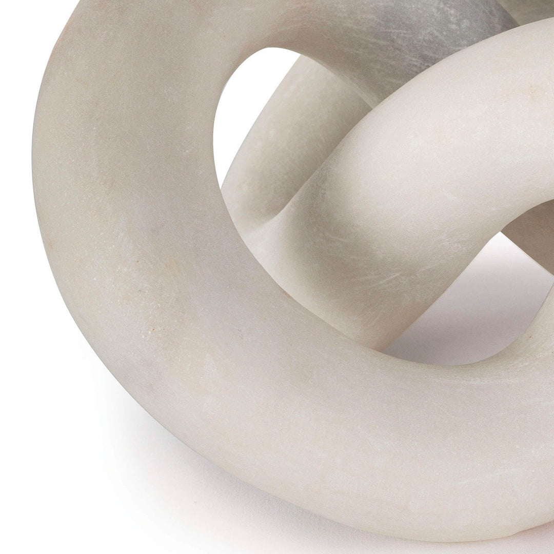 Close up of marble knot sculpture in white.