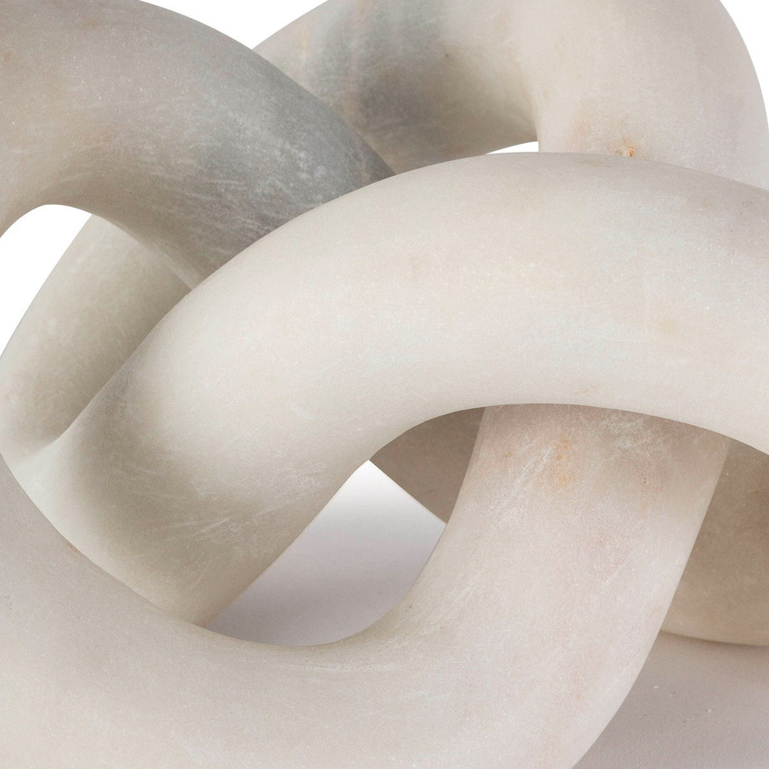 Close up of white marble knot sculpture.