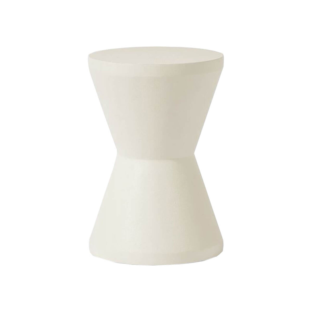 The Salerno Stool in a white faux Belgian linen finish with an hourglass shape.