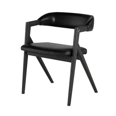 A modern and comfortable black leather dining chair with a curved back and sloped seat made of faux black leather.