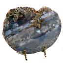 Brass display stand holding a decorative rock.