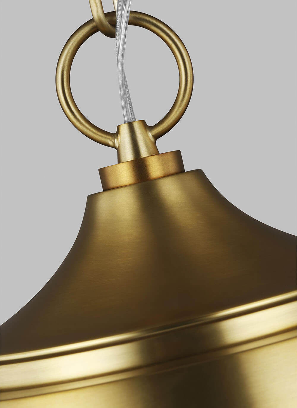 Burnished brass ring detail attachment on a globe kitchen pendant.