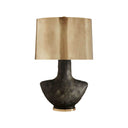 The Armato Table Lamp has a stained black metallic porcelain sculpture-like base and an oval antique brass shade.