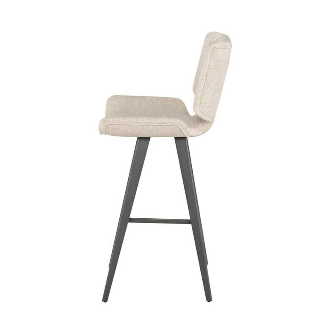 Side view of the off white modern bar stool with a large, upholstered seat and dark grey legs.