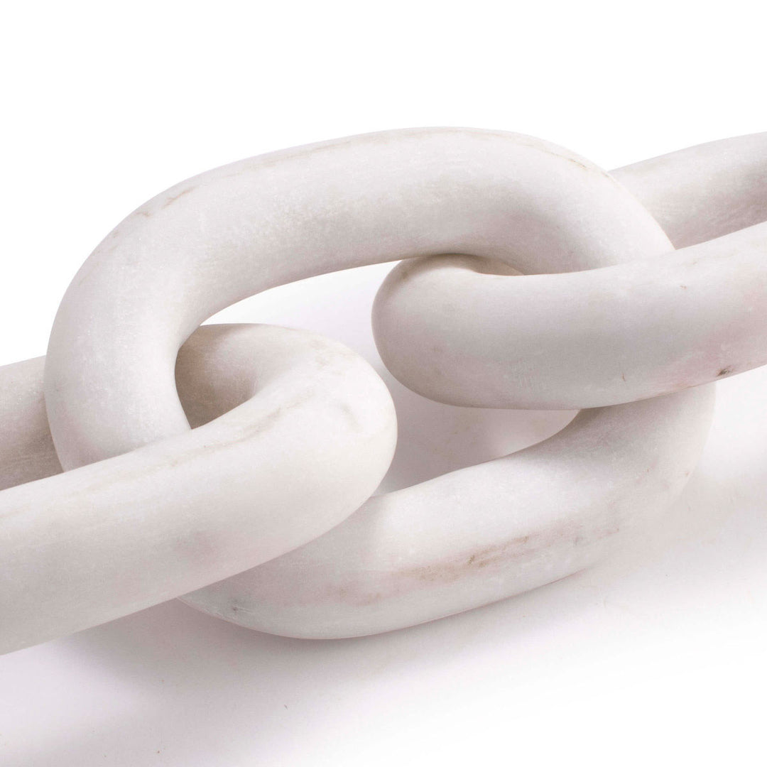 Close up of links that form this white marble chain decorative object.