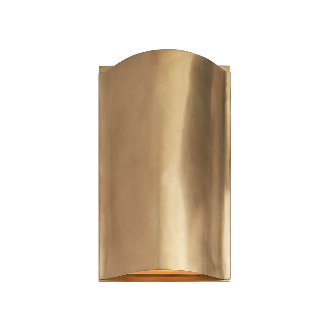 The Avant Curve Wall Sconce is a modern sconce made of curved, antique burnished brass metal and an interior light.