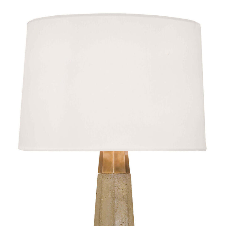 Linen shade and tapered hexagonal concrete column base on the statement table lamp.
