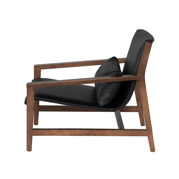 Side view of a black leather armchair with a solid birch wood frame.