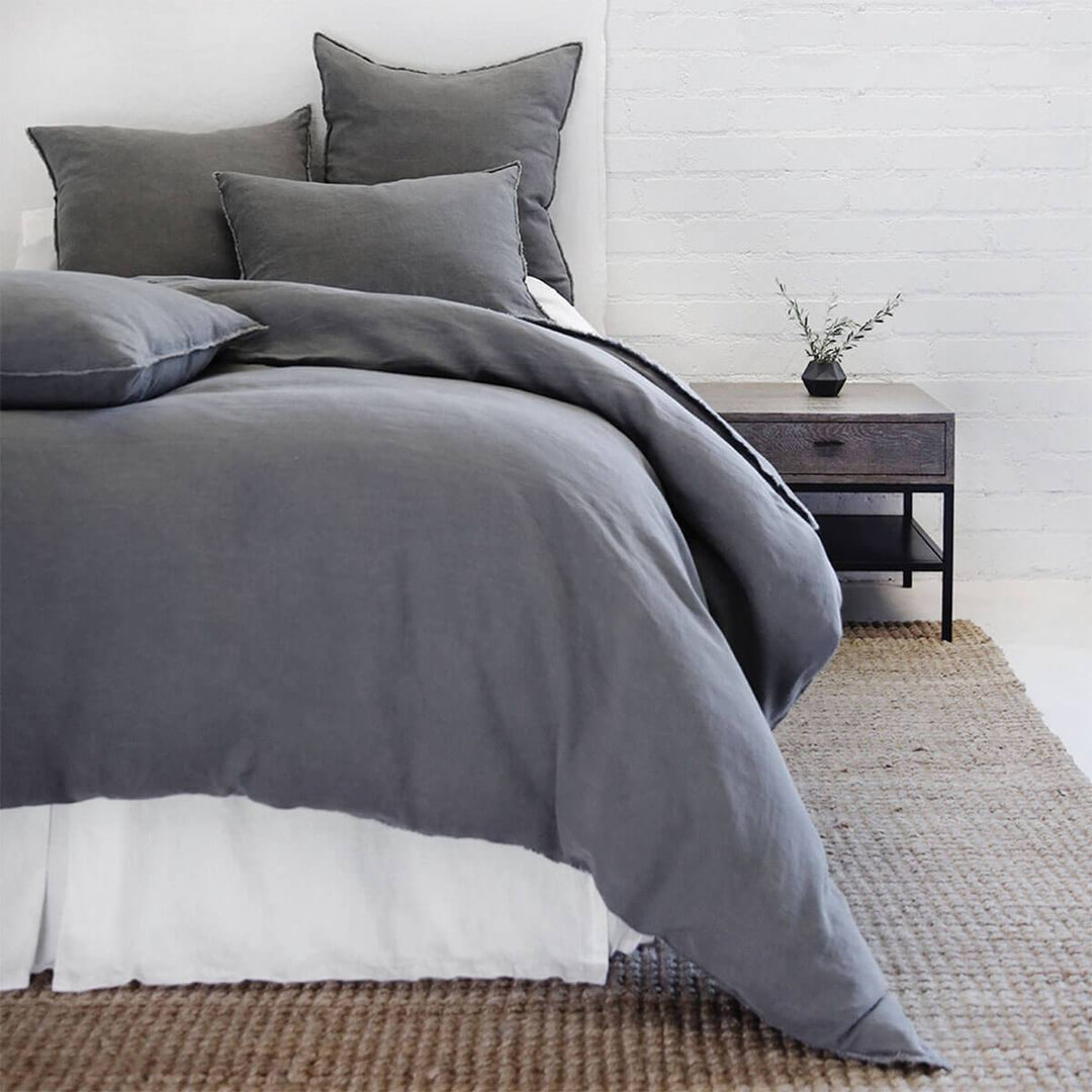 The Berlin Bedding Collection in the colour midnight is a 100% linen duvet with frayed edges and tie closures.
