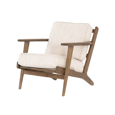 The Puebla Lounge Chair, featuring thick cushions in avant natural, is a comfortable and versatile chair with a weathered finish.