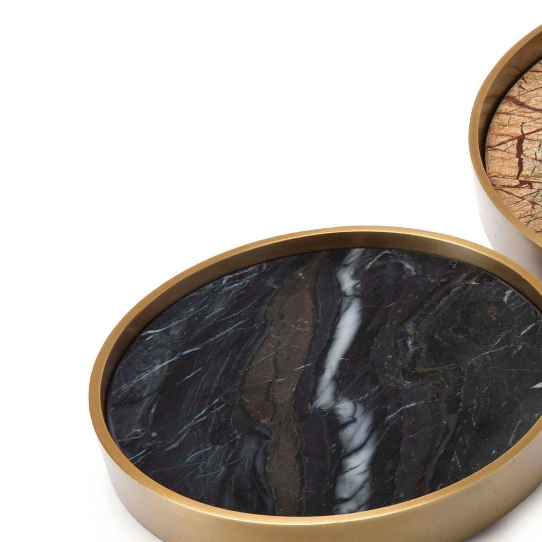 Modern black marble tray surrounded by a natural brass frame.