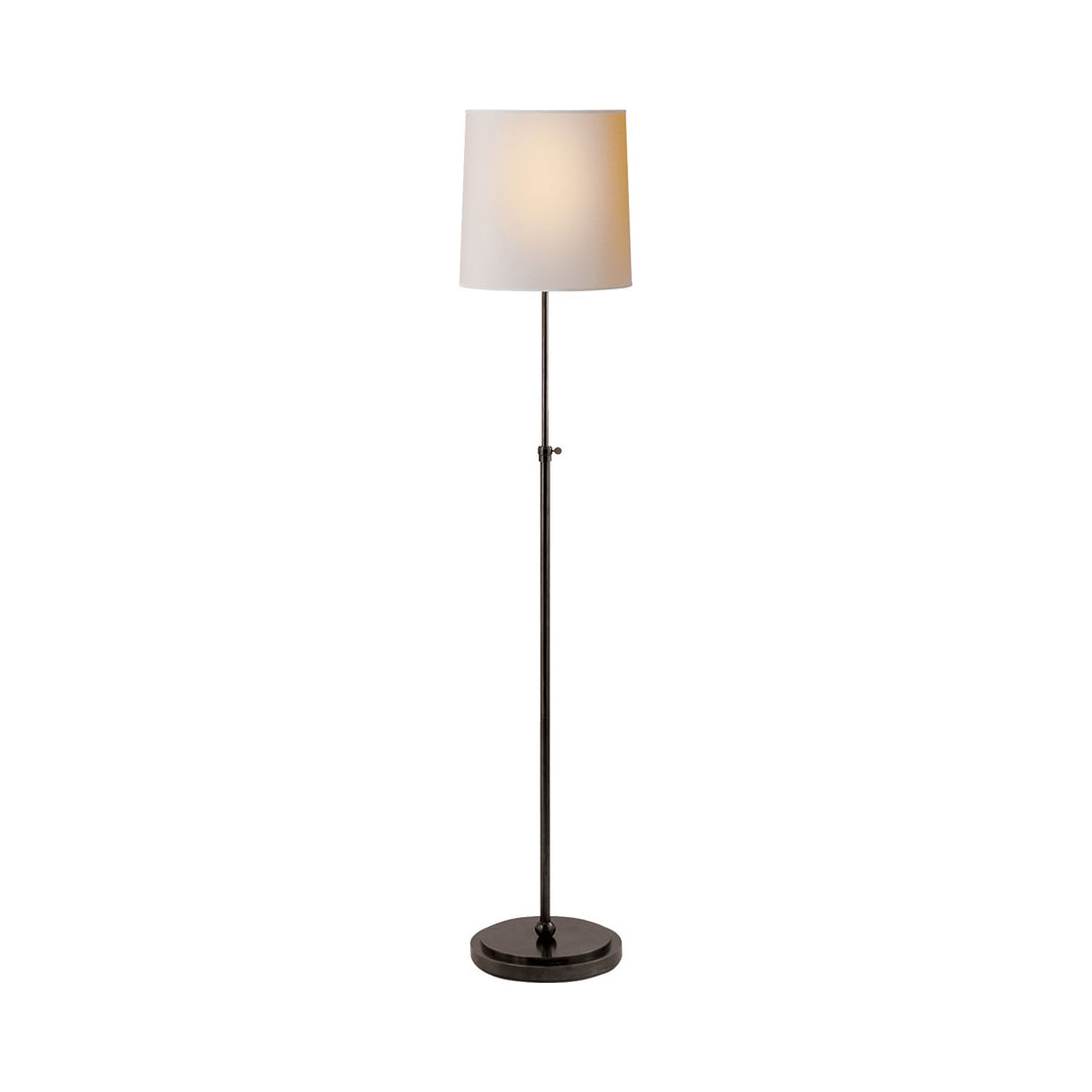 Traditional simple floor lamp in bronze with a paper shade.