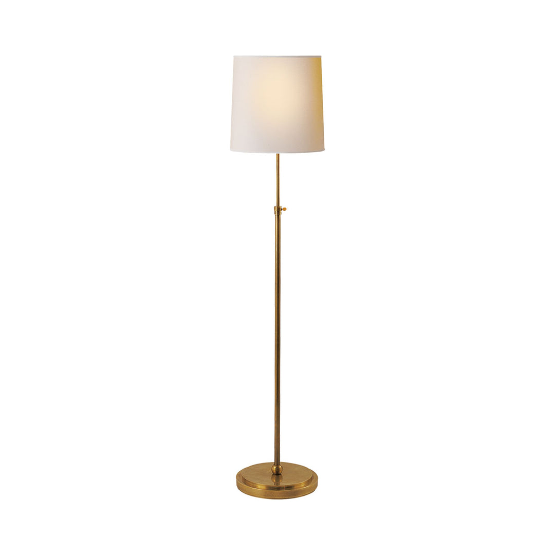 Traditional simple floor lamp in hand rubbed brass with a paper shade.