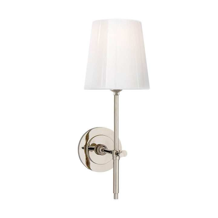 The Bryant Wall Sconce is a traditional sconce with a round backplate and simple arm with a polished nickel finish and a white glass shade.