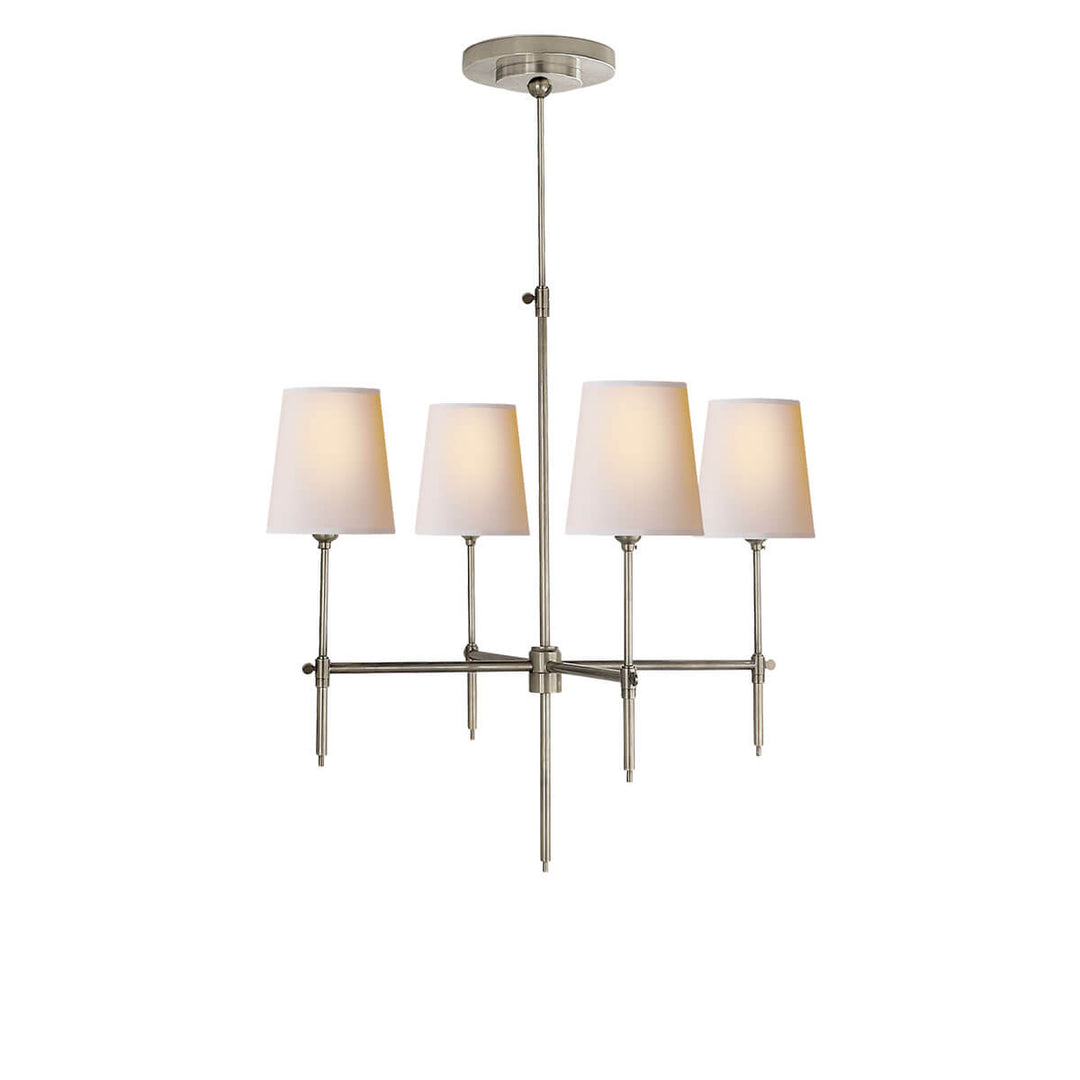 The Bryant Chandelier has a traditional candelabra frame with antique nickel arms and four lights with natural paper shades.