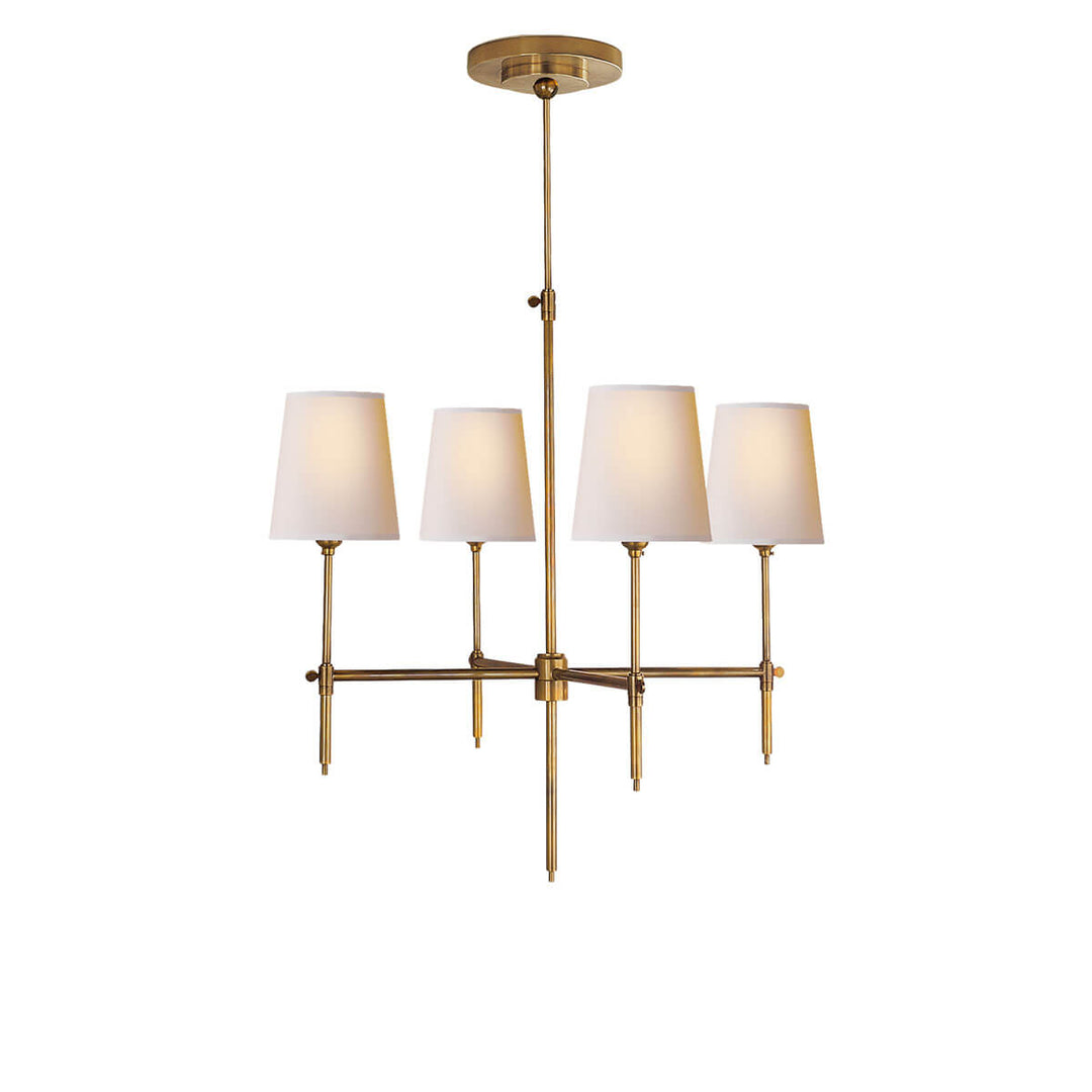 The Bryant Chandelier has a traditional candelabra frame with antique burnished brass arms and four lights with natural paper shades.