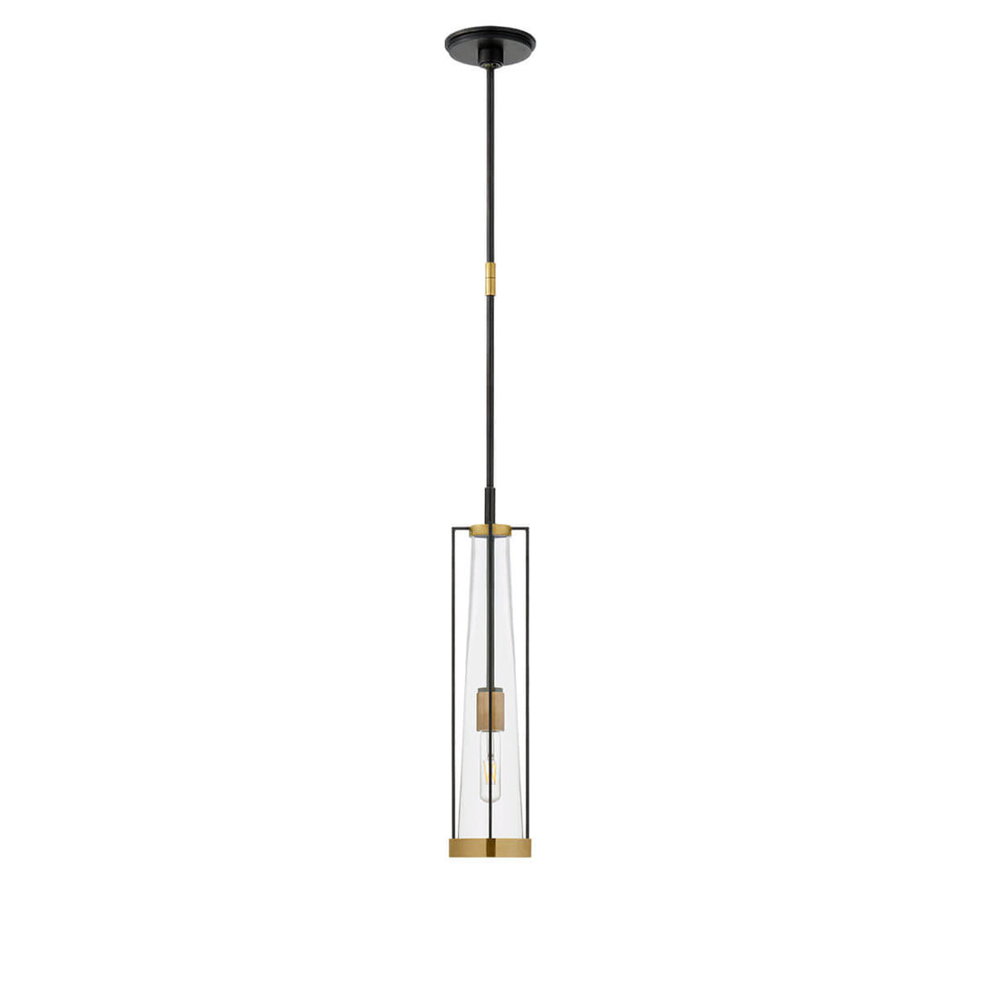 The Calix Tall Pendant has a tall, slim bronze cage with brass details around a clear glass, cylinder shade.