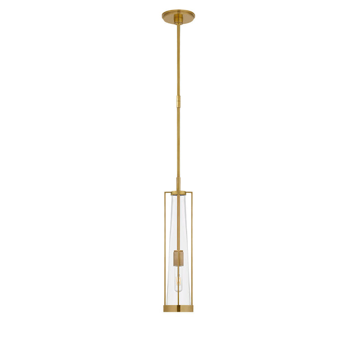 The Calix Tall Pendant has a tall, slim hand rubbed antique brass cage around a clear glass, cylinder shade.