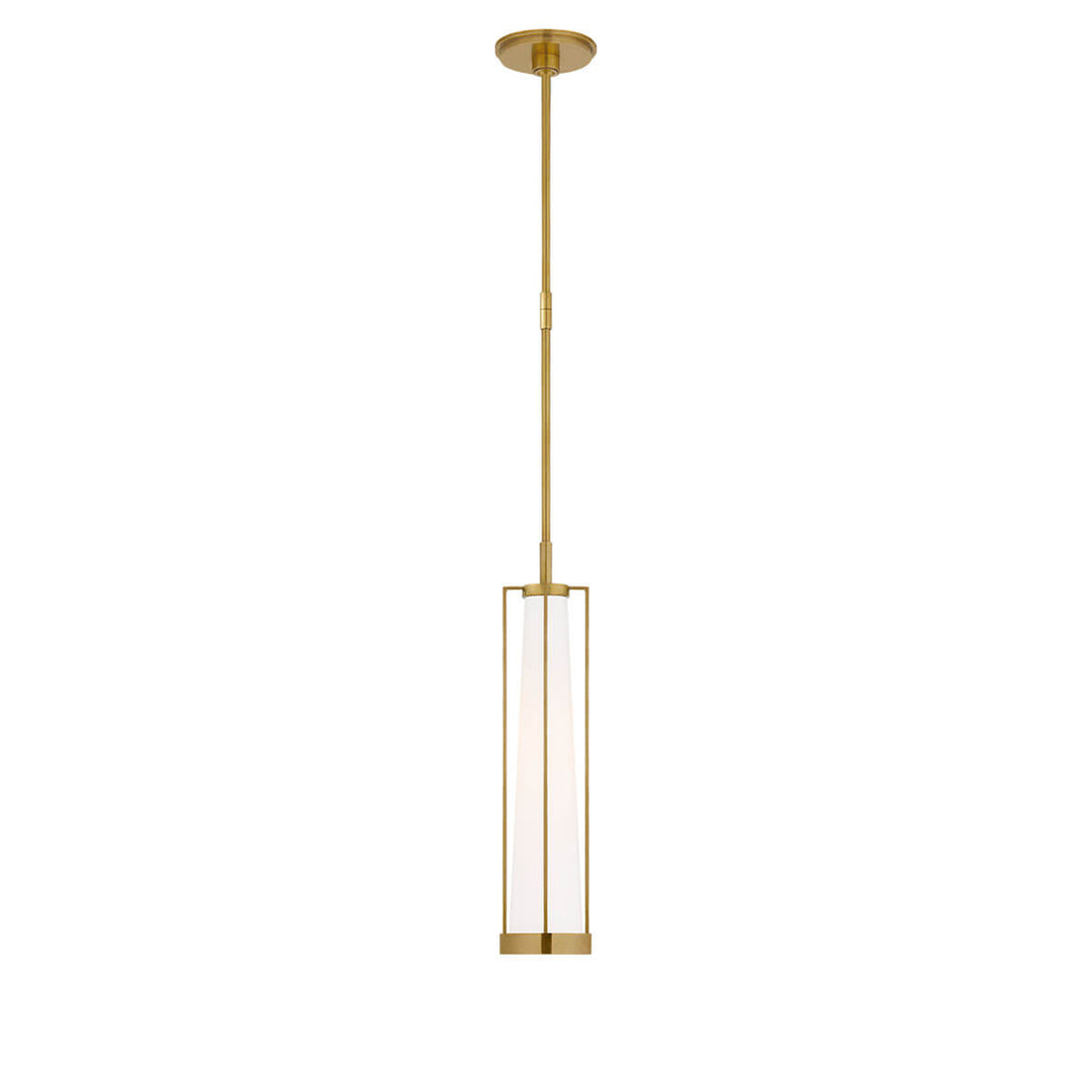 The Calix Tall Pendant has a tall, slim hand rubbed antique brass cage around a white glass, cylinder shade.