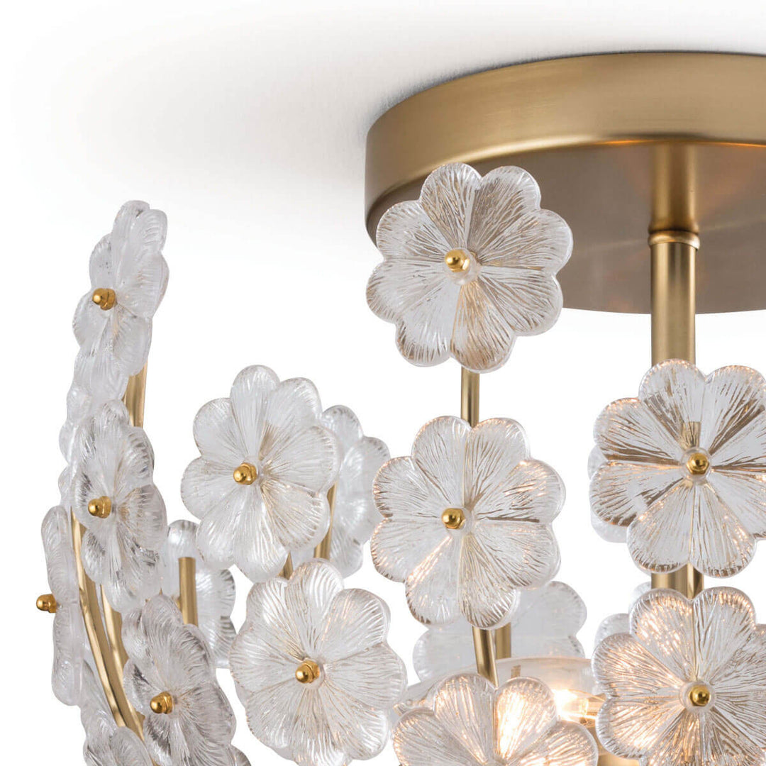 Natural brass canopy and cast glass flowers on the intricate, feminine flush mount light.