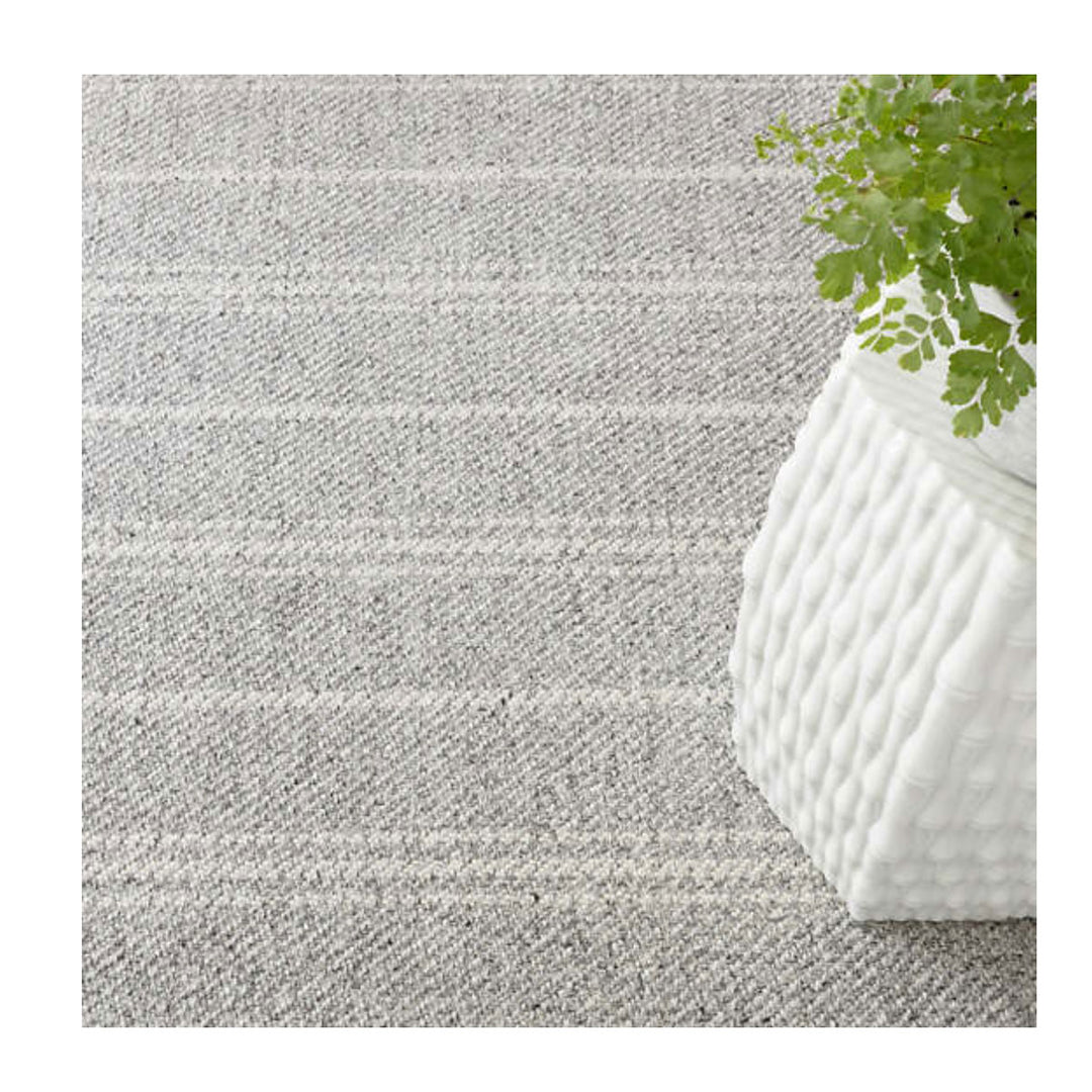 Classic grey and white stripe indoor outdoor rug. Outdoor rug used for a patio or entrance.