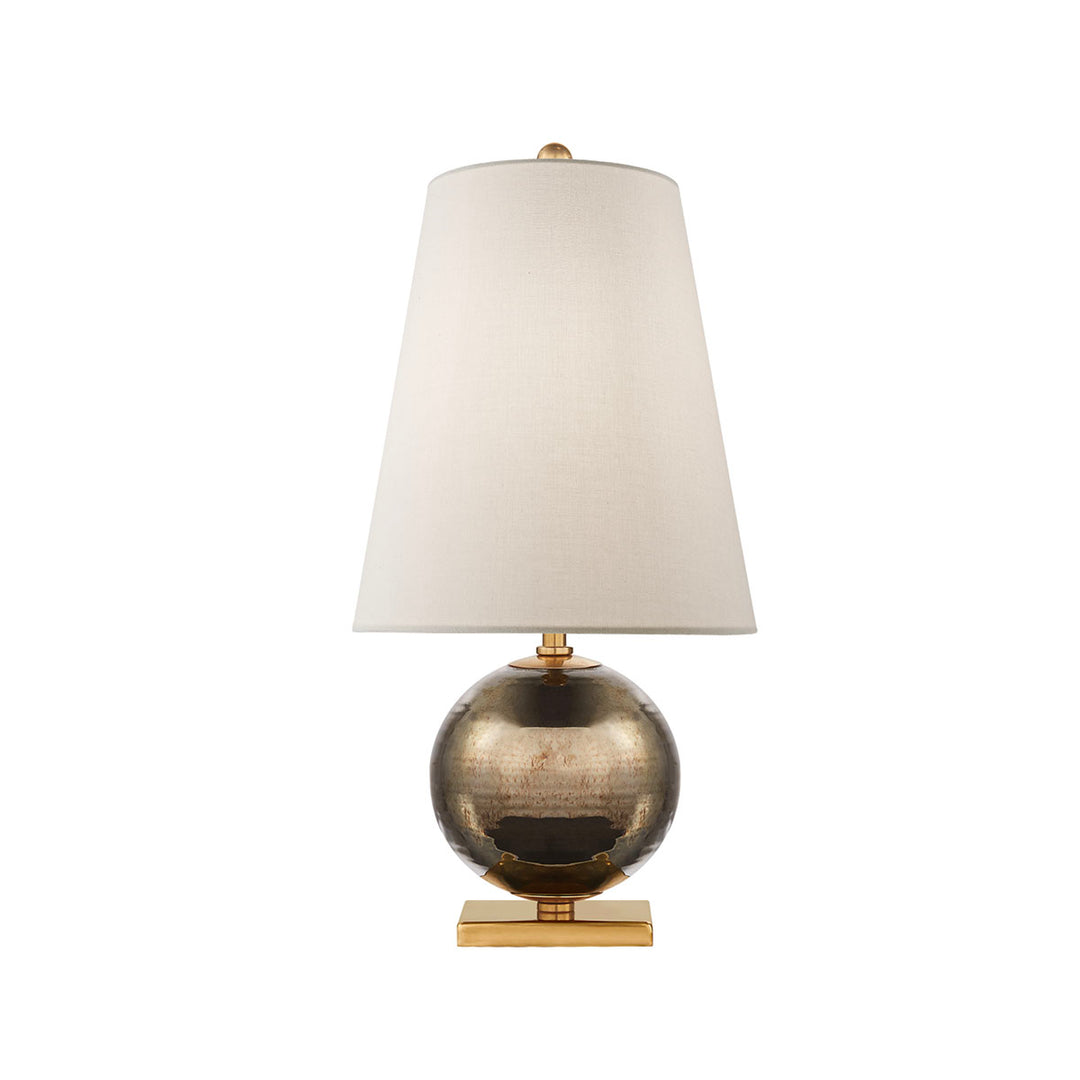 Table lamp with round glazed pearl base and off-white linen shade.