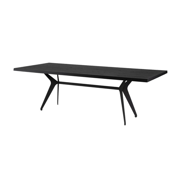 Contemporary dining room table with angled stainless steel legs and a black onyx tabletop.