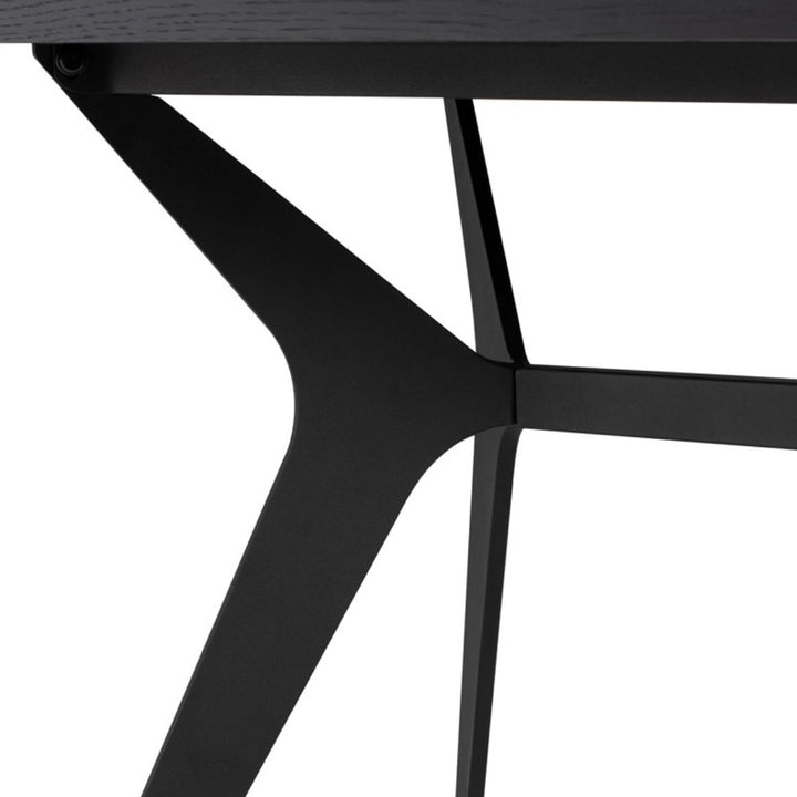Angled leg details on the modern black dining table.