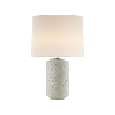 The Darina Table Lamp is a sculptural lamp with a volcanic ivory, textured base with a white linen shade.
