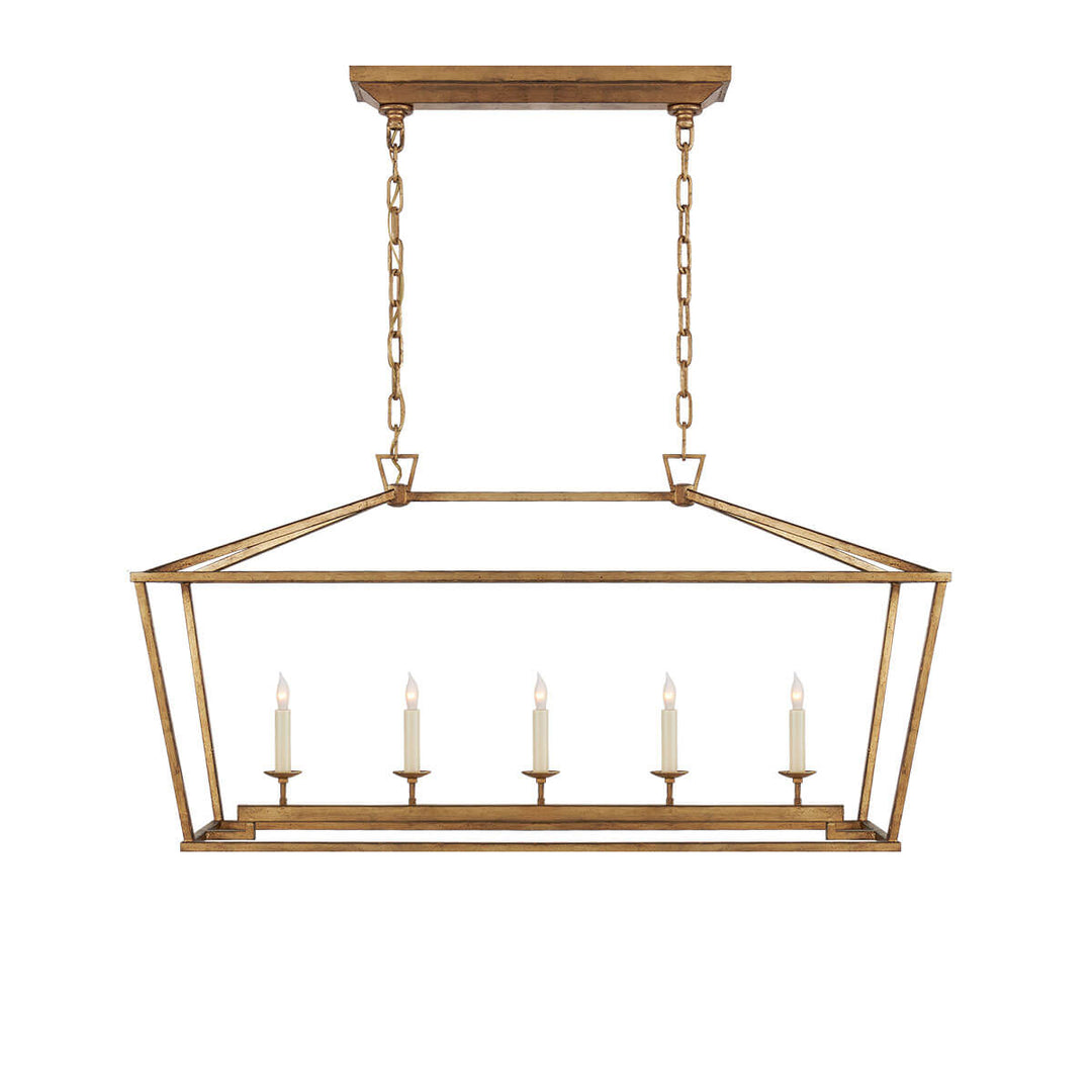 The Darlana Linear Lantern Lantern is an gilded iron metal lantern frame with five candle-like lights.