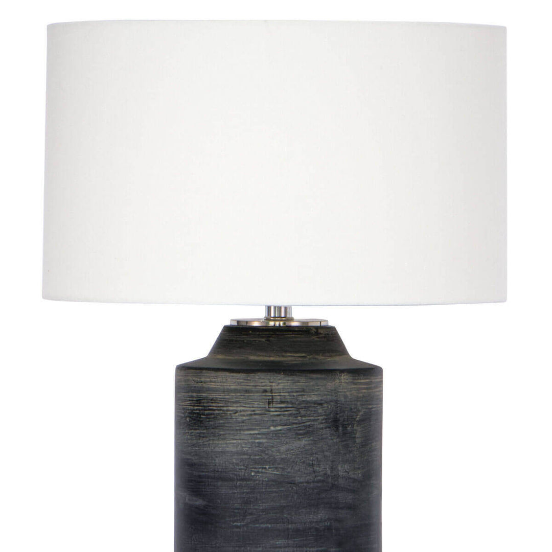 Textured ceramic base, natural linen shade, and polished nickel details on a modern table lamp with an industrial feel.