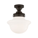A modern flush-mount light with traditional elements in a bronze and white glass finish.
