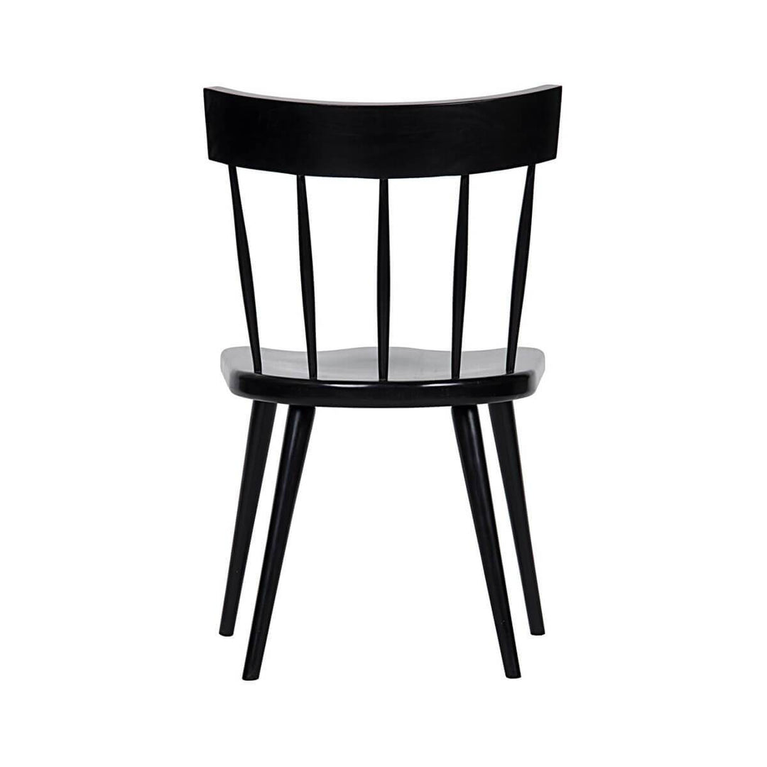 Back view of the traditional dining chair with a rounded, spindle back and rubbed black finish.