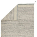 The Flora Rug Collection in Grey/Ivory folded to show the 100% cotton backing.