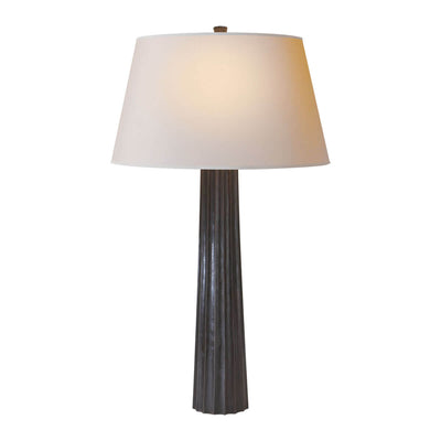 The Fluted Spire Table Lamp is a tall slim table lamp with an aged iron, textured body and natural paper shade.