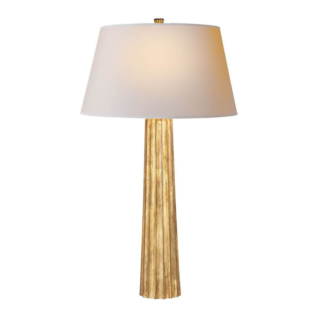 The Fluted Spire Table Lamp is a tall slim table lamp with a gilded iron, textured body and natural paper shade.