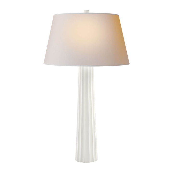 The Fluted Spire Table Lamp is a tall slim table lamp with a plaster white, textured body and natural paper shade.