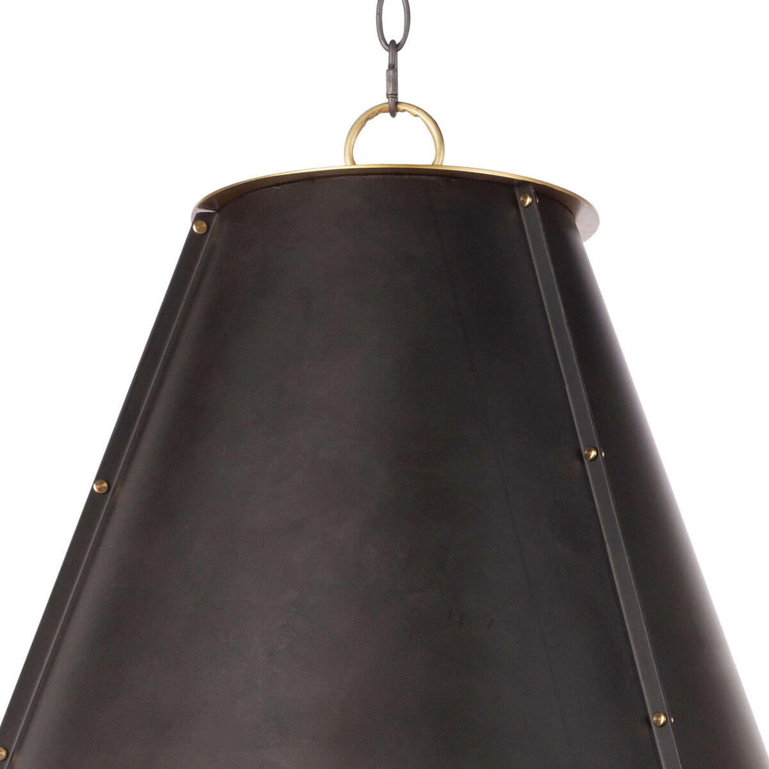 Closeup of the black metal cone shaped pendant light with stud details.