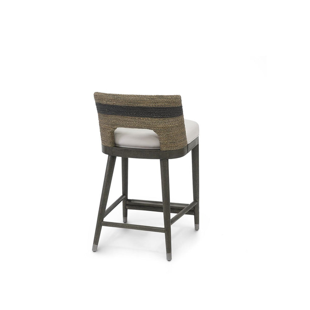 Bohemian counter stool with brown and black striped, lampakanai rope seat and white upholstered seat.