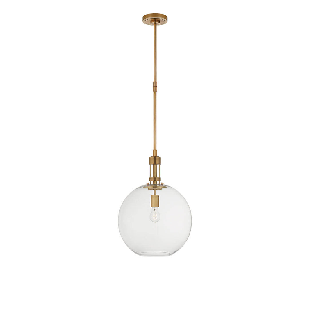 The Gable Pendant has a clear glass globe suspended on a thin hand-rubbed antique brass column.