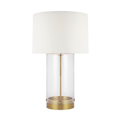 The Bilbao Table Lamp with a clear glass cylindrical base and brass detailing. 