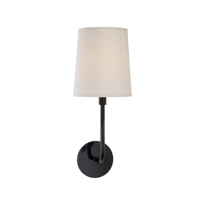 The Go Lightly Wall Sconce has a slender, curved arm and baseplate in a charcoal finish with a silk lamp shade.