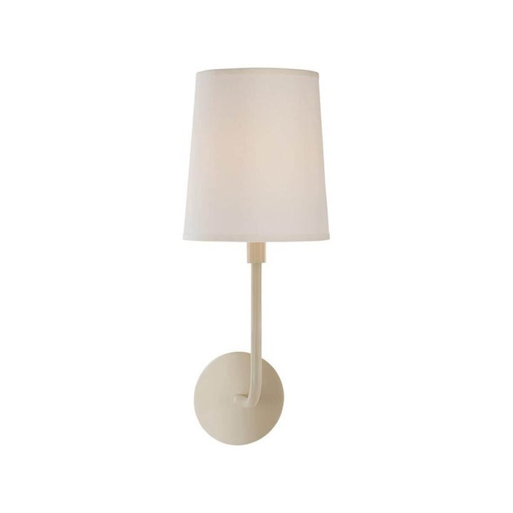 The Go Lightly Wall Sconce has a slender, curved arm and baseplate in a china white finish with a silk lamp shade.