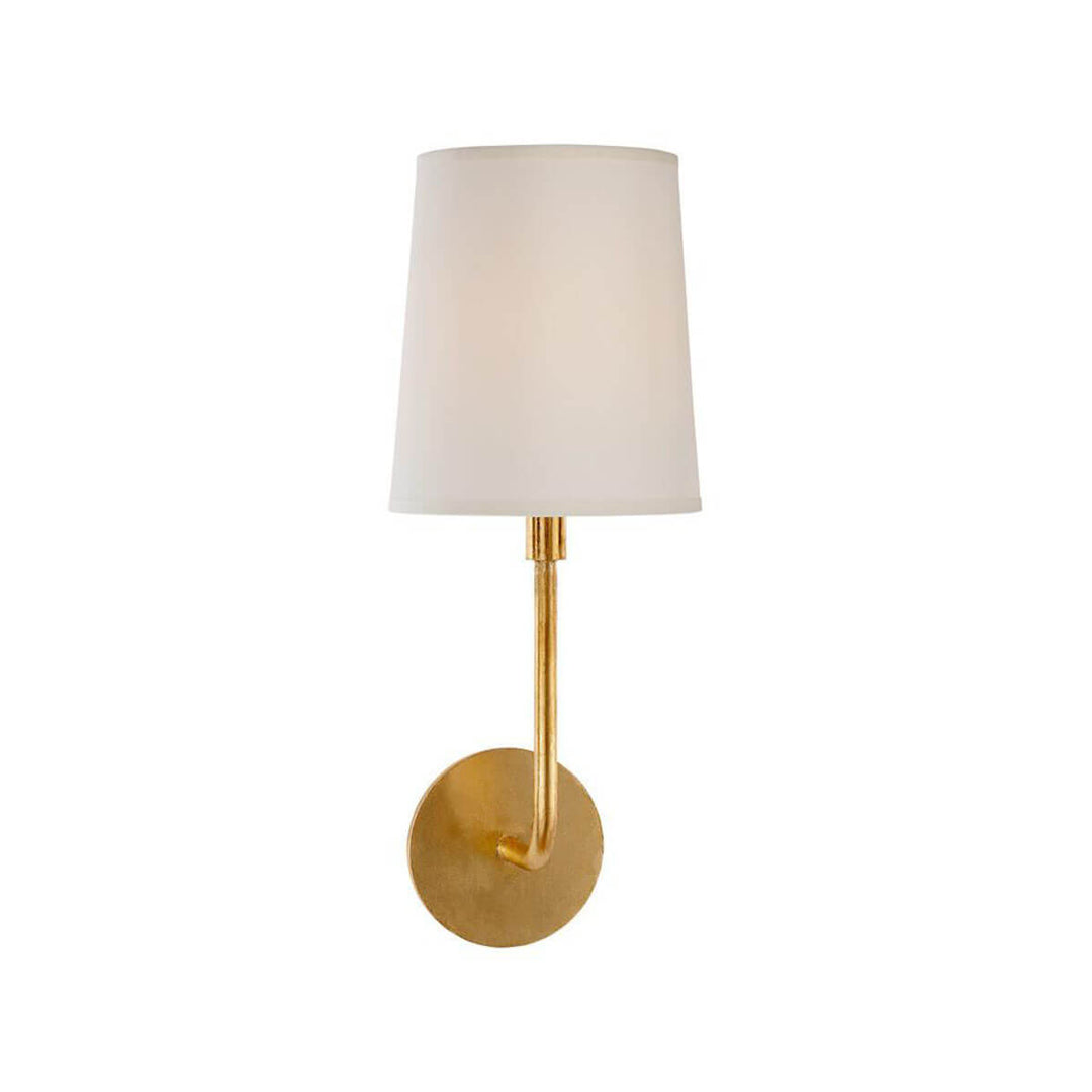 The Go Lightly Wall Sconce has a slender, curved arm and baseplate in a gild finish with a silk lamp shade.