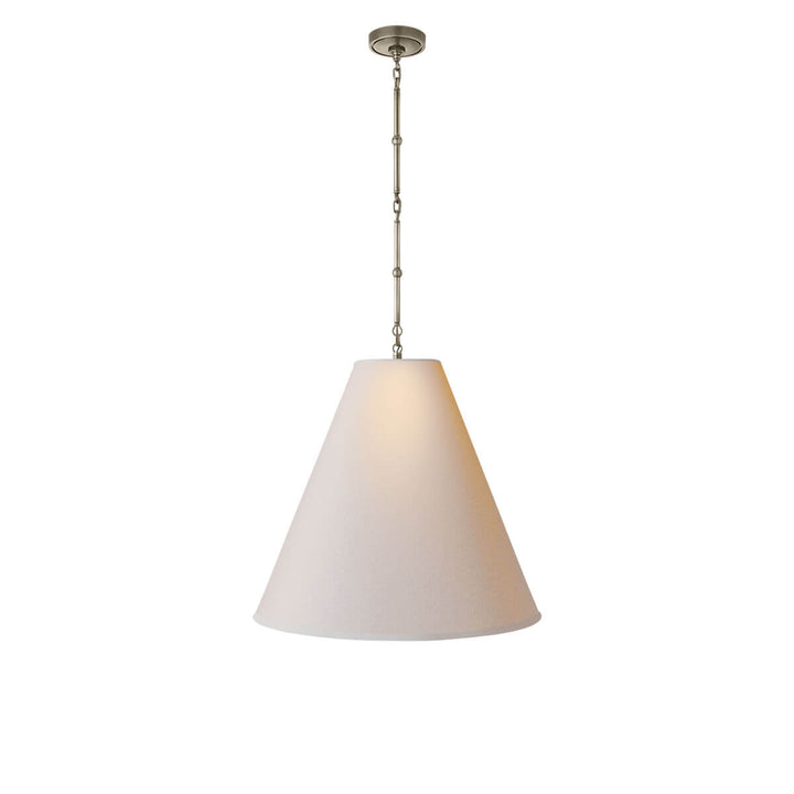 The Goodman Hanging Lamp has a delicate antique nickel chain with a natural paper, cone shaped shade.