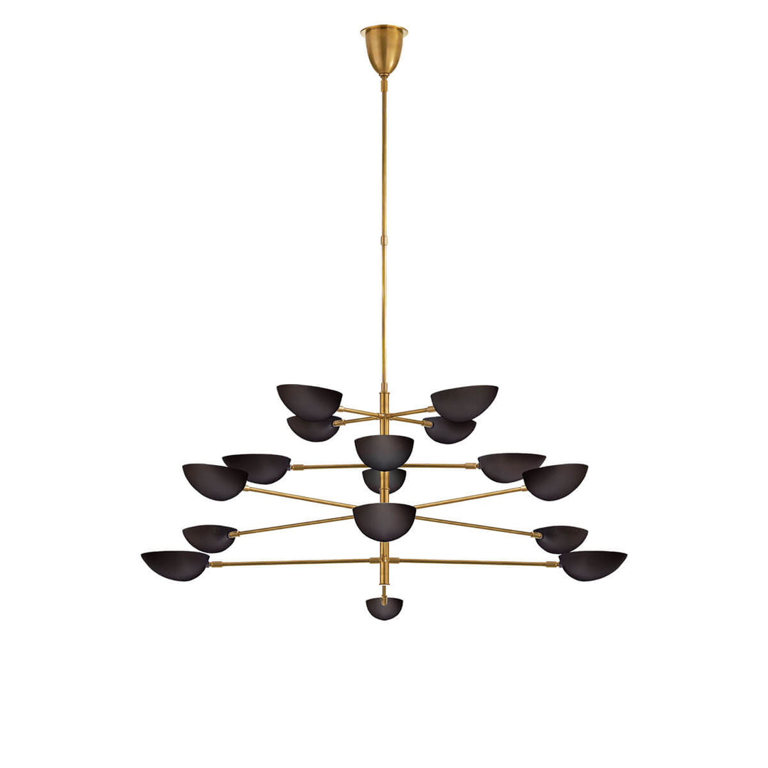 The Graphic Grande Multi-Tier Chandelier has a rod stem and tiered arms in a hand-rubbed antique brass finish and has sixteen lights with black glass, pedal shaped shades.